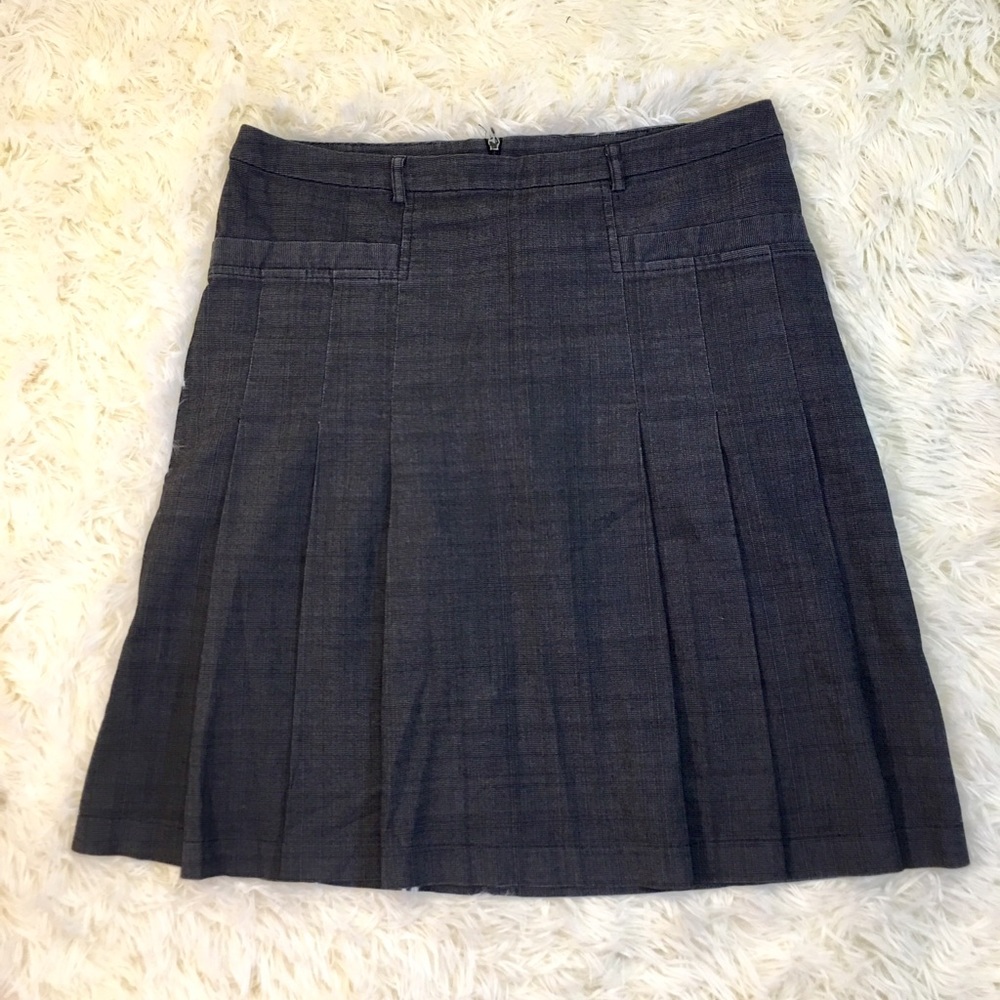 Pleated black denim skirt.